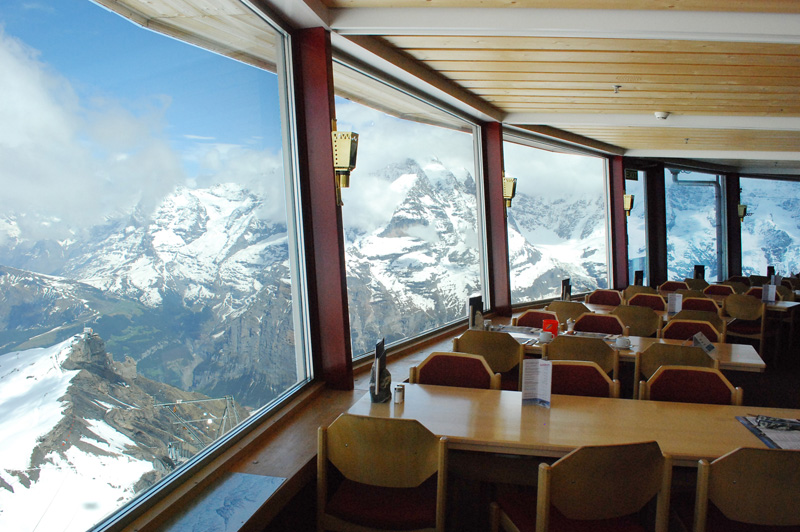 views of snow capped mountains through restaurant windows