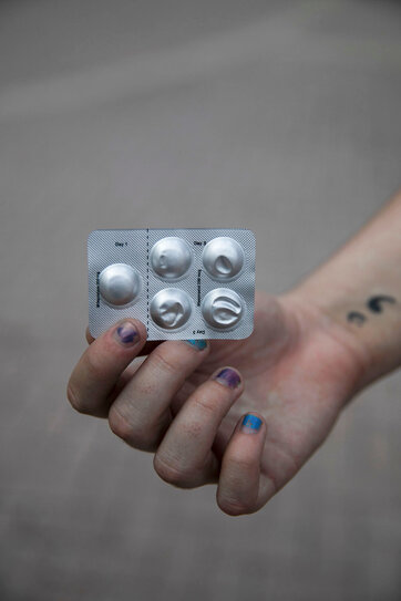 A hand of Cody, showing the blister pack of abortion pills they ordered online.
