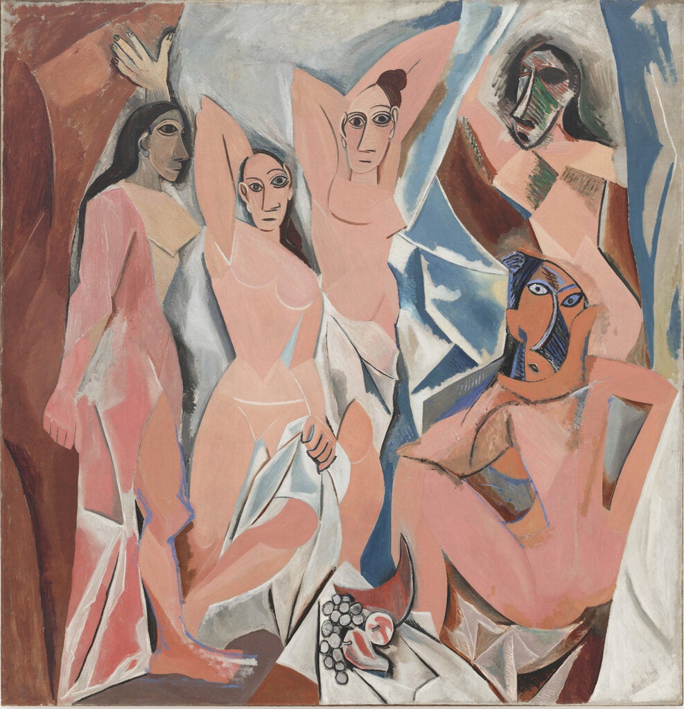 A Cubist painting shows five nude women rendered in pink tones on a background of brown, white and blue. They are standing and sitting with sharply angled arms and torsos, and the two at right are wearing West African masks.