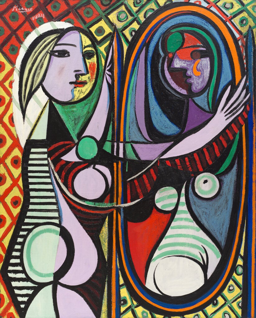 A Cubist painting by Picasso of a girl looking at the mirror, contemplating her reflection, her body a jumble of circles and orbs. There is a diamond Harlequin pattern; the bodies are made up of many bold colors.