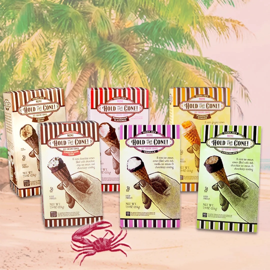 6 boxes of different Trader Joe's Hold the Cone! Mini Ice Cream Cones are on the sandy beach with palm trees in the background