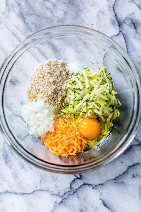 zucchini, cheese, egg and panko in a bowl