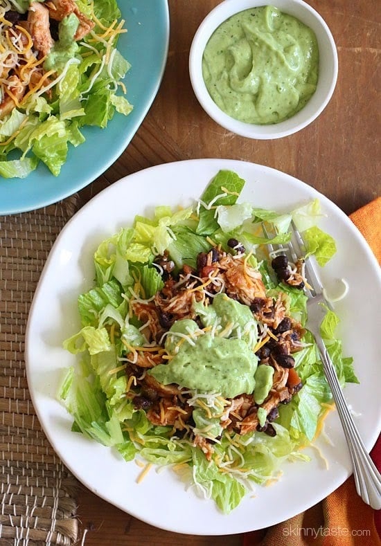 This simple slow cooker chicken taco salad is high in fiber and protein which means it's very satisfying – all for under 300 calories. Trust me, you won't miss the tortillas!