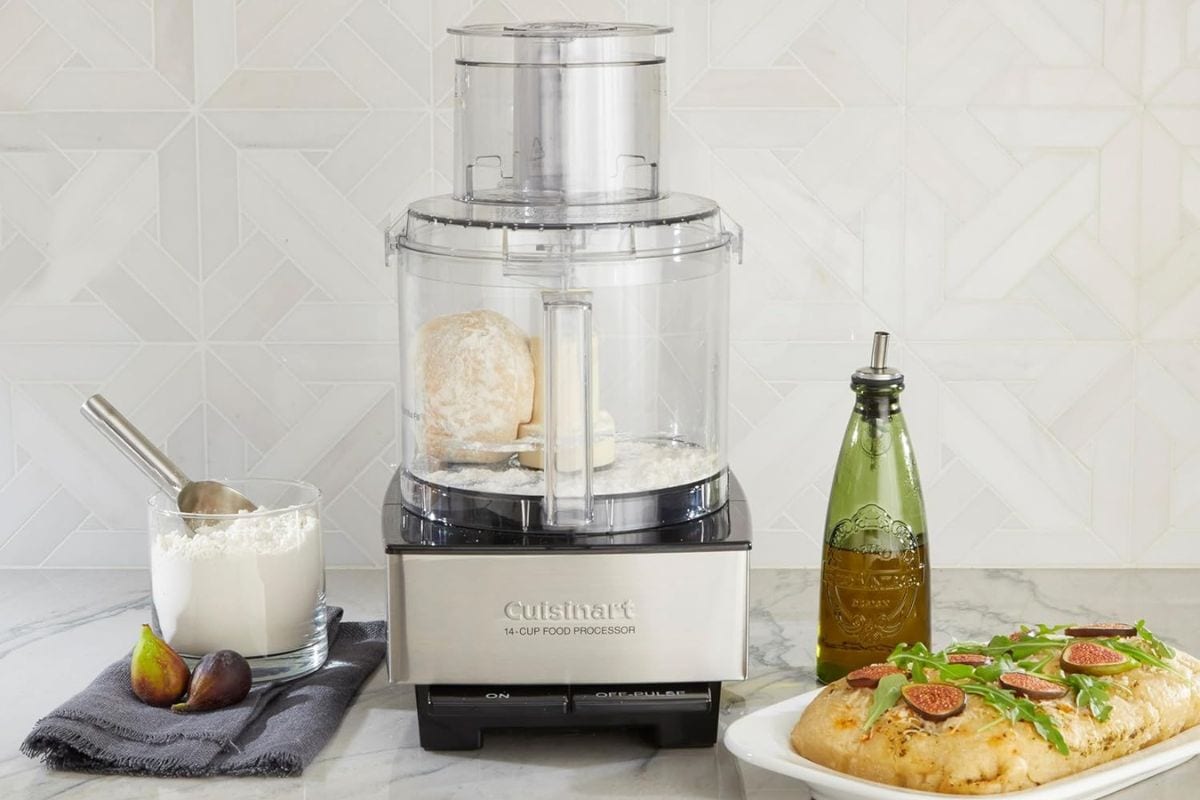 Cuisinart food processor on counter next to bread